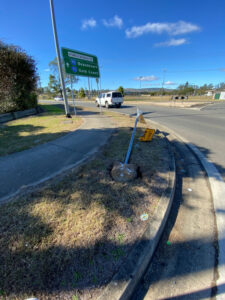 Roundabout smash scatters debris, damages traffic signs